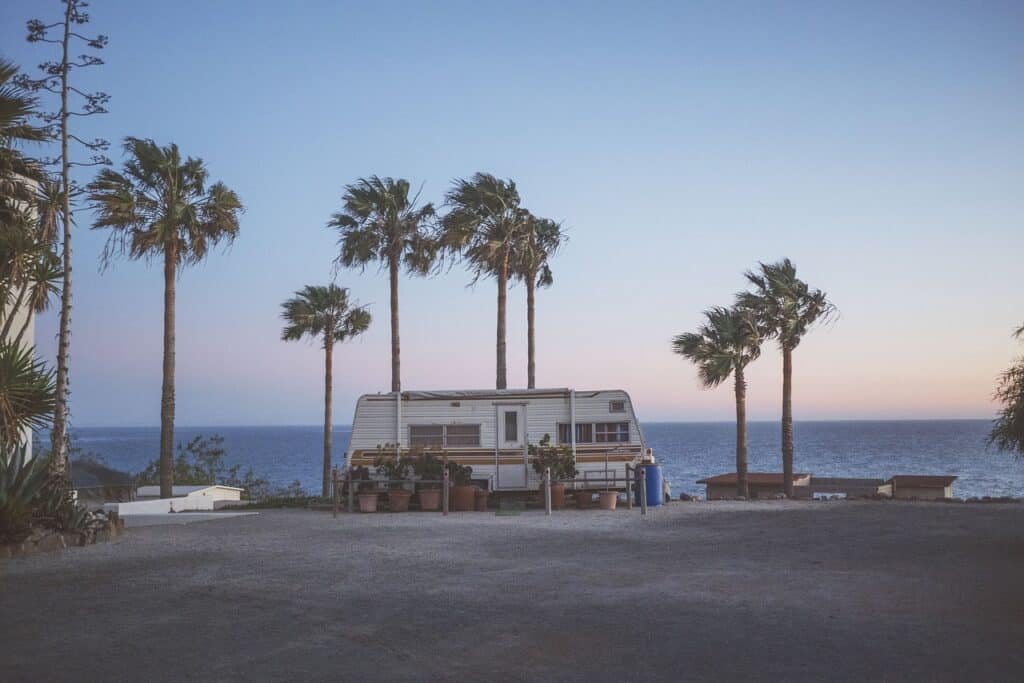 RV under palm trees by the ocean